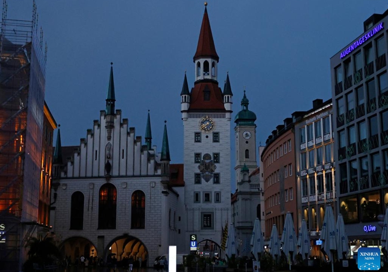Photo taken on July 30, 2022 shows a night view of the old city hall in Munich, Germany. Some landmark structures across the country have reduced their night illumination to save on electric power. (Photo by Philippe Ruiz/Xinhua)
