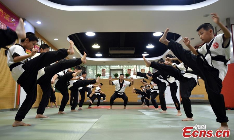 Teenagers practice Kungfu wrestling during the summer break at a training center in Shijiazhuang, north China's Hebei Province, Aug. 3, 2022. The Yang style Kungfu westling was founded in 1937 and included in the eighth batch of intangible cultural heritage list of Shijiazhuang in 2020. (Photo: China News Service/Zhai Yujia)