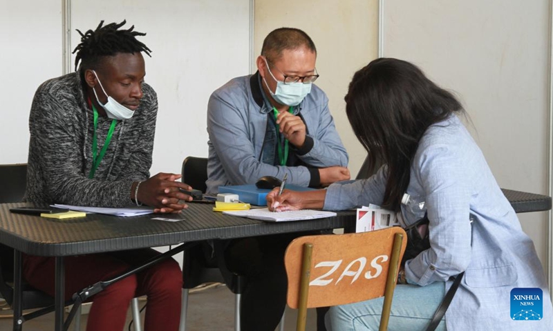 A job seeker leaves her details to a potential employer at a job fair in Harare, Zimbabwe, on Aug. 2, 2022. The two-day Zimbabwe Job Fair opened Tuesday. Hosted by the China Africa Economic and Culture Exchange Research Center and Victory Milestone Recruitment, the event lived up to its billing as scores of job seekers exchanged notes with potential employers and left the curriculum vitae (CV) for possible placements.(Photo: Xinhua)