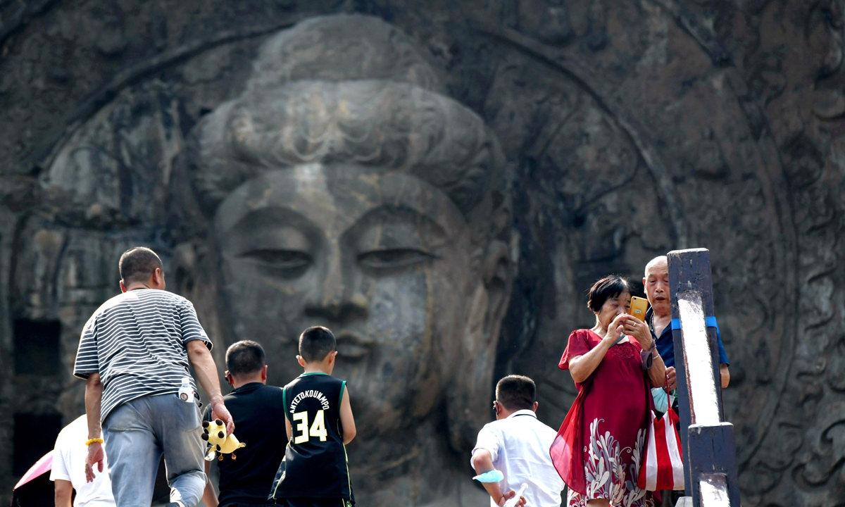 A major renovation project is completed at the Longmen Grottoes Fengxian Temple on August 3, 2022, in Luoyang, Central China's Henan Province, revealing the 