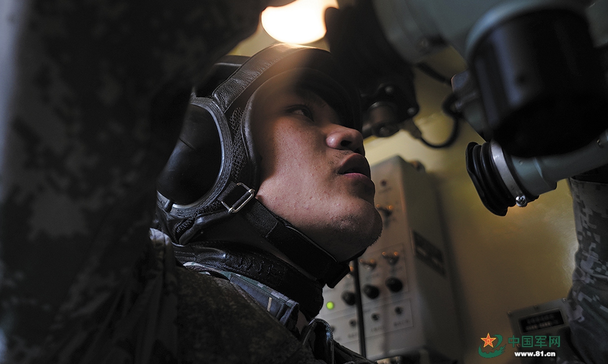An artilleryman assigned to an artillery detachment with a brigade under the PLA 81st Group Army uses the gun sight to lock the target from the cockpit of a self-propelled howitzer during a day-and-night live-fire training exercise on July 11, 2022. (eng.chinamil.com.cn/Photo by Wu Chao, Liu Qiang and Liang Tianchi)