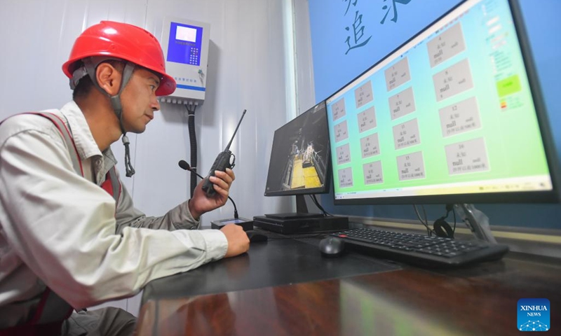 A staff member checks the cable through the monitoring system of Wanjiali Road power tunnel in Changsha, central China's Hunan Province, Aug. 4, 2022. Changsha has been experiencing high temperatures recently, bringing the peak of summer electricity consumption. Many power supply lines in the newly-built Wanjiali Road power tunnel have been laid and put into use, transmitting electric energy for the areas along the line. (Xinhua/Chen Zeguo)
