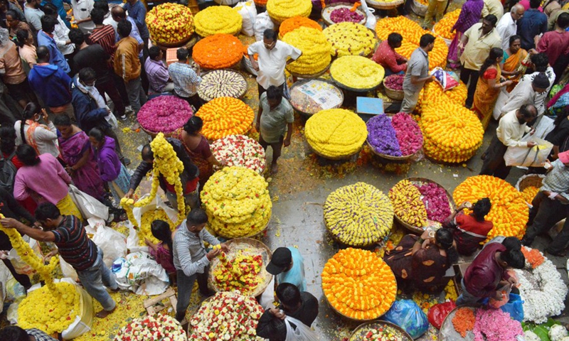 Indian people of Hindu religion shop for flowers at a wholesale market in Bangalore, India, Aug. 4, 2022.(Photo: Xinhua)
