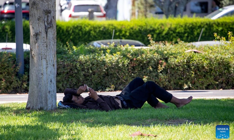 A man lies in the shade in Limassol, Cyprus, on Aug. 4, 2022. The Cypriot Department of Meteorology on Thursday issued a new yellow warning for high temperature.(Photo: Xinhua)