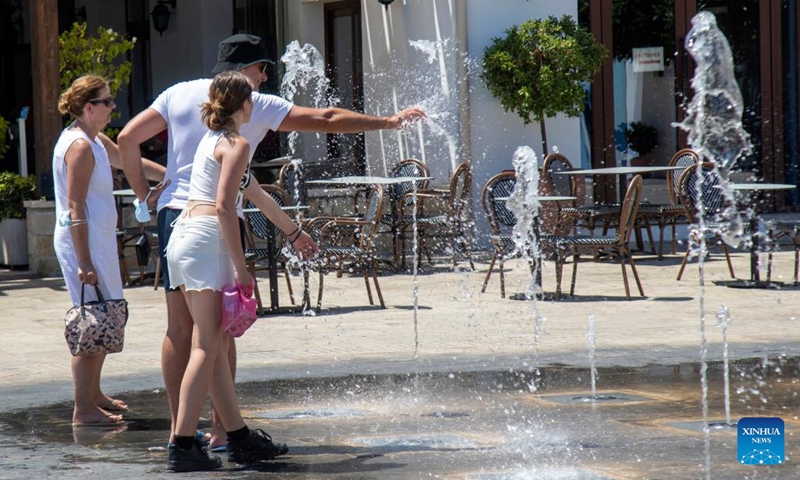 People cool off at a splash pad in Limassol, Cyprus, on Aug. 4, 2022. The Cypriot Department of Meteorology on Thursday issued a new yellow warning for high temperature.(Photo: Xinhua)