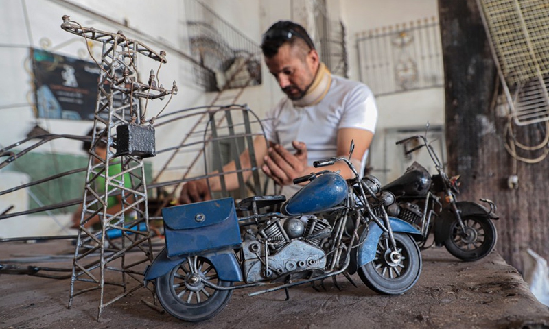 Palestinian hearing impaired Fakher Hamad works inside his small workshop in Gaza City on Aug. 2, 2022. (Photo: Xinhua)