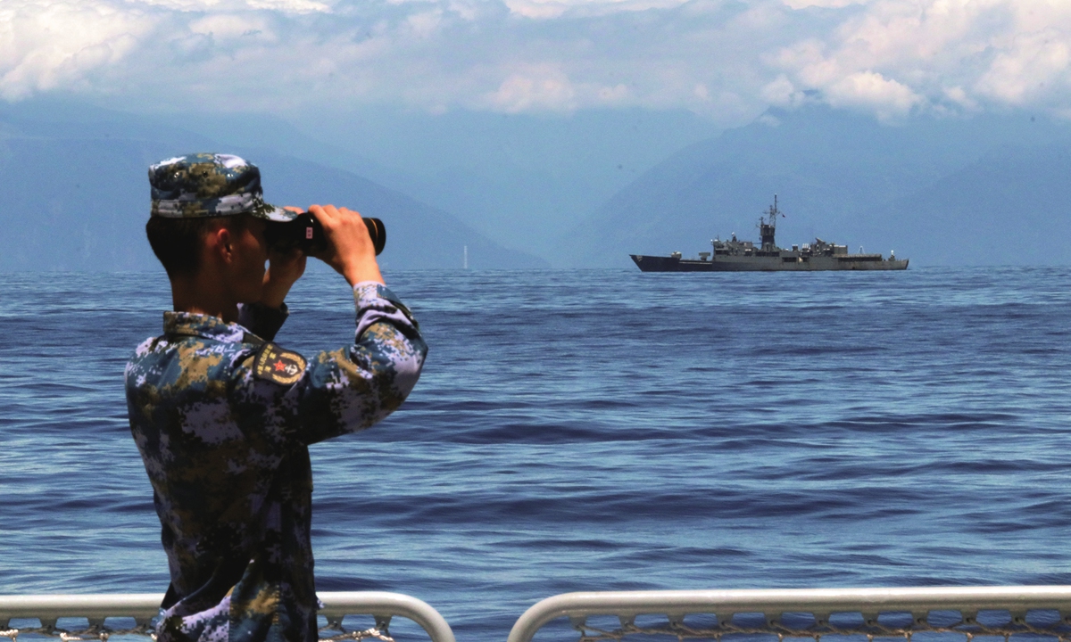 A People's Liberation Army（PLA） soldier looks around with a telescope on August 5, 2022, as the Navy of the PLA Eastern Theater Command continues drills the waters around the island of Taiwan. Photo: Xinhua