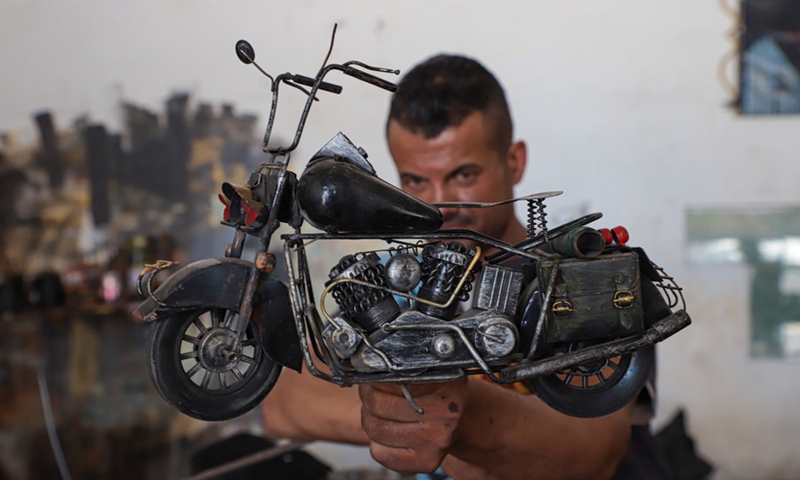 Palestinian hearing impaired Fakher Hamad displays his work from iron at his workshop in Gaza City on July 18, 2022. (Photo: Xinhua)