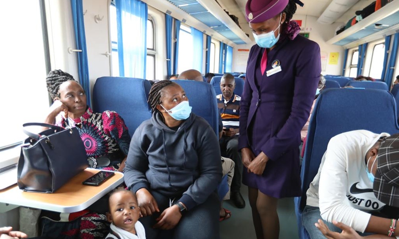 Train crew Fionah communicates with passengers on a Mombasa-Nairobi Railway passenger train, July 29, 2022. Launched on May 31, 2017, the 480 km Mombasa-Nairobi Standard Gauge Railway (SGR), financed mainly by China and constructed by China Road and Bridge Corporation (CRBC), has fostered job creation for local people. Photo: Xinhua