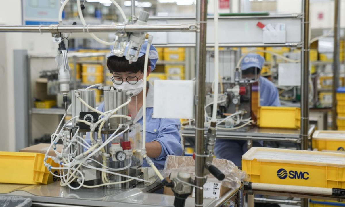 Staff members work at a factory of SMC Corporation in Beijing Economic-Technological Development Area of Beijing, capital of China, June 4, 2022. Photo:Xinhua