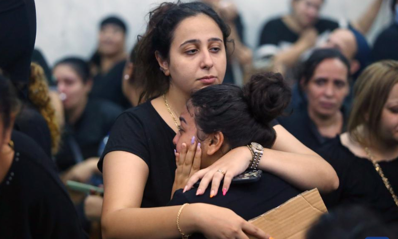 People mourn during a funeral for victims of a church massive fire in Giza, Egypt, on Aug. 14, 2022. At least 41 people were killed and 12 injured in a massive fire that broke out in a Coptic church in Egypt's Giza Province on Sunday, the Egyptian Health Ministry said. Photo: Xinhua
