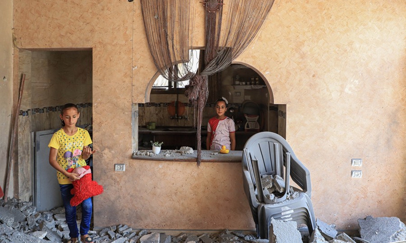 Palestinians Zina, 7, and Jana Shamlakh, 9, are seen inside their house which was damaged by an Israeli airstrike in Gaza City, on Aug. 9, 2022. (Photo: Xinhua)