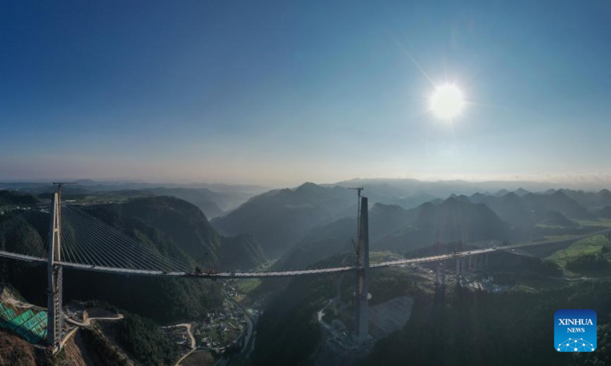 Aerial panorama photo taken on Aug 19, 2022 shows the construction site of the Longli River bridge in Longli County, southwest China's Guizhou Province. The 1,260-meter-long bridge was joined together on Friday. Photo:Xinhua