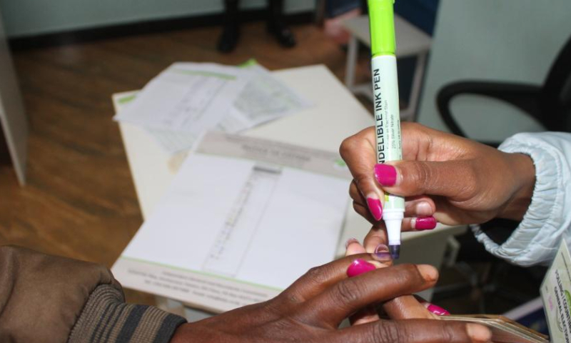 A staff member marks a voter's finger after voting at a polling station in Kiambu County, Kenya, on Aug. 9, 2022. Kenya held general elections on Tuesday. (Photo by Joy Nabukewa/Xinhua)