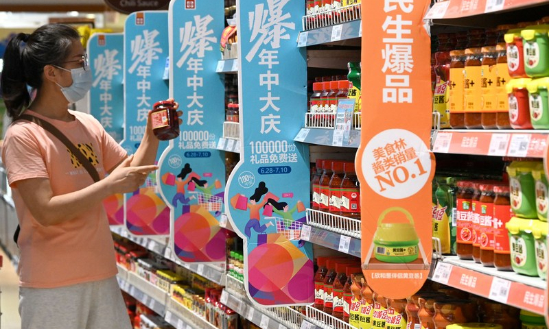 A woman shops at a supermarket in Congtai District of Handan, north China's Hebei Province, July 9, 2022.