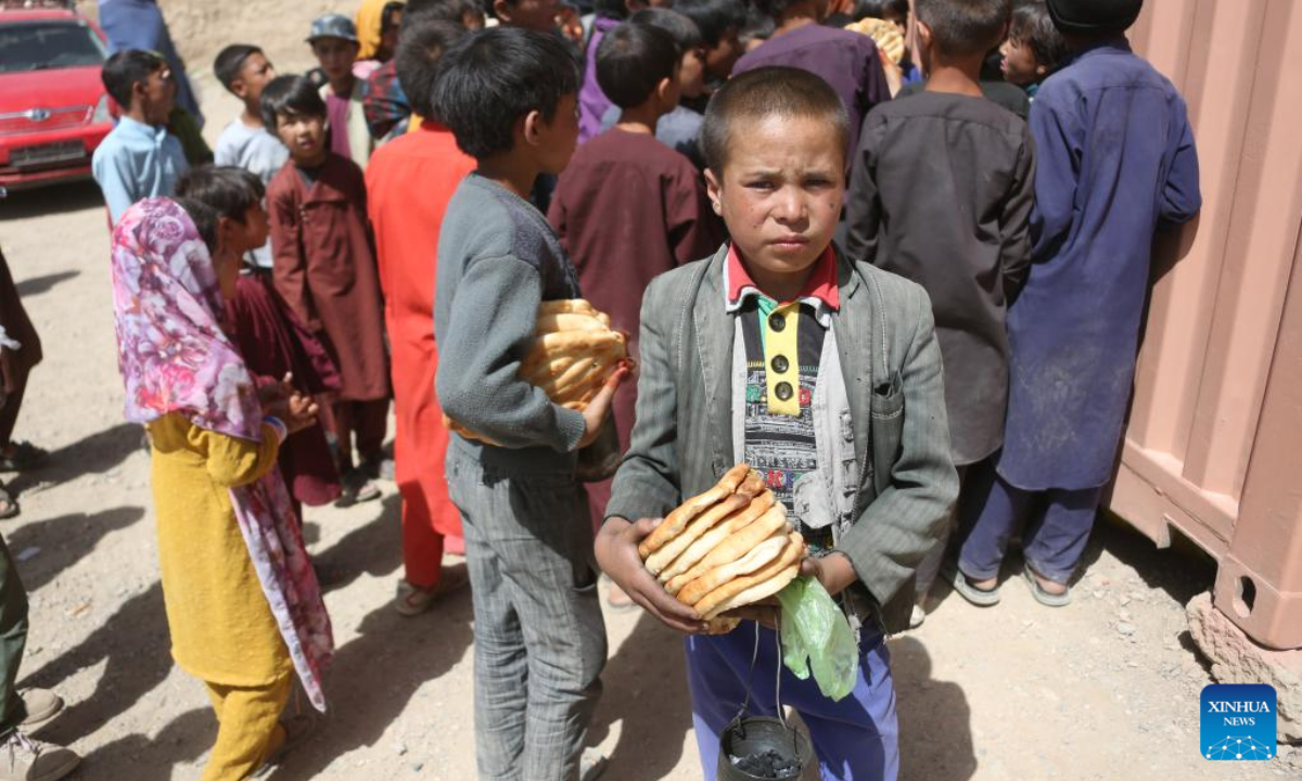 Local kids receive food after attending training on cultural heritage knowledges in Bamyan province, Afghanistan, July 13, 2022. Photo:Xinhua