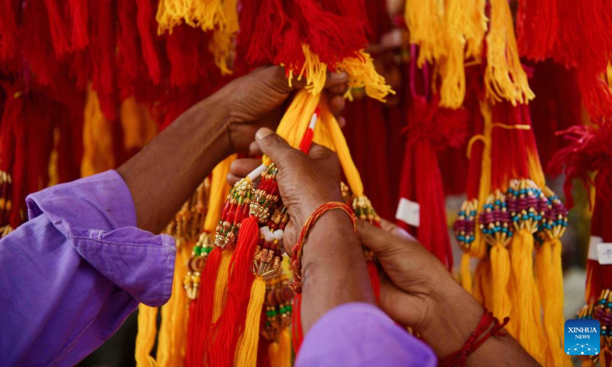 Customers buy Rakhi sacred threads for the Raksha Bandhan festival at a shop in Agartala, India, Aug 11, 2022. Photo:Xinhua