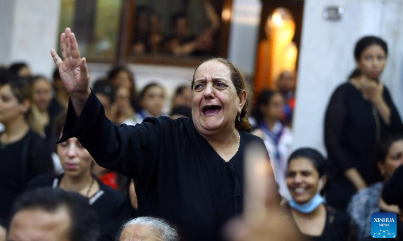 A woman mourns during a funeral for victims of a church massive fire in Giza, Egypt, on Aug. 14, 2022. At least 41 people were killed and 12 injured in a massive fire that broke out in a Coptic church in Egypt's Giza Province on Sunday, the Egyptian Health Ministry said. Photo: Xinhua