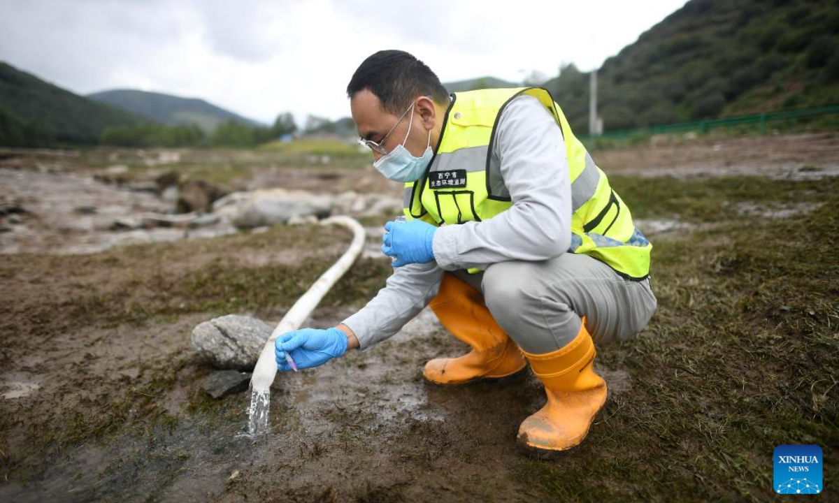 A technician of an ecological and environmental monitoring station checks water quality at Shadai Village, Qingshan Township of Datong Hui and Tu Autonomous County in northwest China's Qinghai Province, Aug 18, 2022. Photo:Xinhua