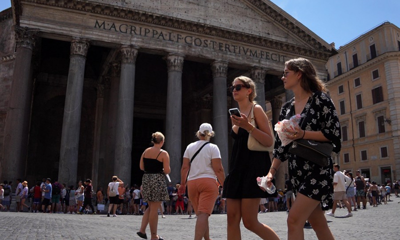 A woman holds bottles of water as she walks past the Pantheon in Rome, Italy, on Aug. 2, 2022.(Photo: Xinhua)