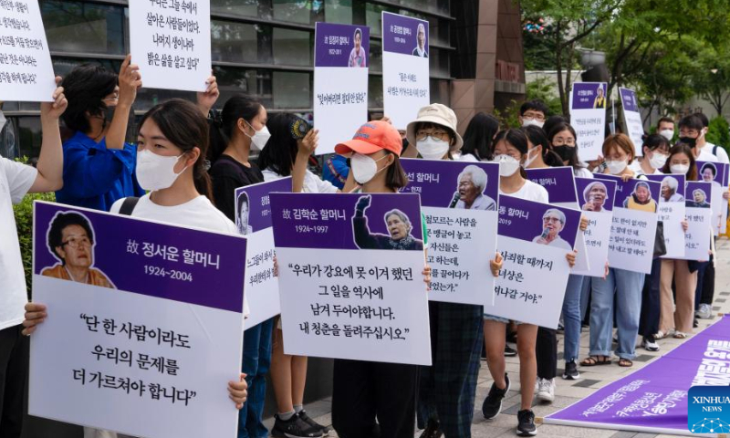 People hold portraits of comfort women and their testimonies during a protest rally held in Seoul, South Korea, Aug. 14, 2022. Comfort women refer to victims forced into sexual slavery by Japanese troops during World War II. The day of Aug. 14 was designated the International Memorial Day for Comfort Women in 2012 by the 11th Asian Alliance Conference for Comfort Women. Photo: Xinhua