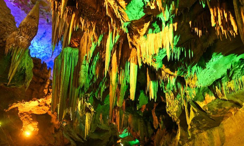 Colored lights illuminate the geological formations at the Benxi Water Cave, a large-scale underground karst, in Benxi, northeast China's Liaoning Province, Aug. 10, 2022. (Photo: China News Service/Yu Haiyang)
Developed about 500,000 years ago, the cave has more than 400,000 cubic meters internal space and a total length of 5,800 meters. Comprising a dry cave and a water cave, it is the world's longest underground karst cave with water.