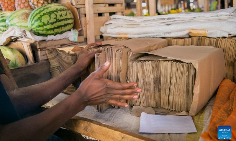 A vendor arranges paper bags at Kimironko market in Kigali, Rwanda, July 14, 2022.(Photo: Xinhua)
