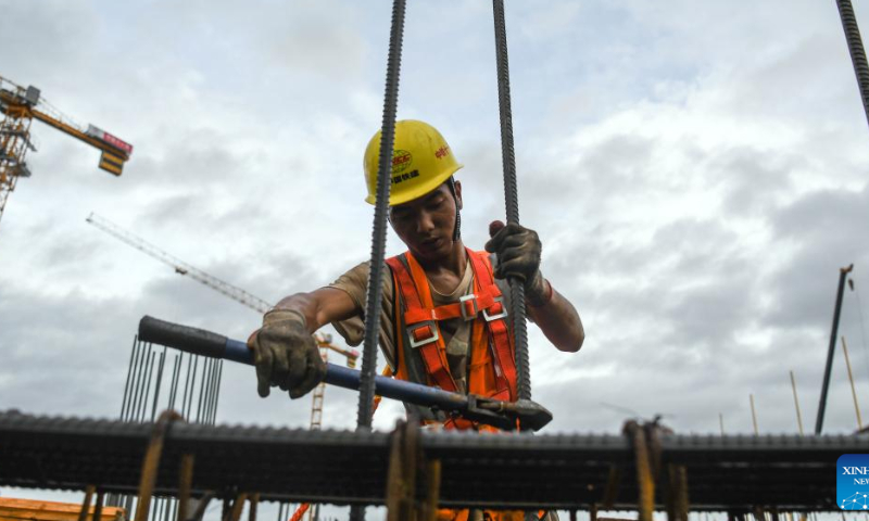 A worker fastens rebar at the construction site of Yulin North Railway Station in Yulin, south China's Guangxi Zhuang Autonomous Region, Aug. 12, 2022. Yulin North Railway Station, covering an area of 49,975 square meters, is one of the seven stations along the Nanning-Yulin high-speed railway with a designed speed of 350 kilometers per hour. Photo: Xinhua
