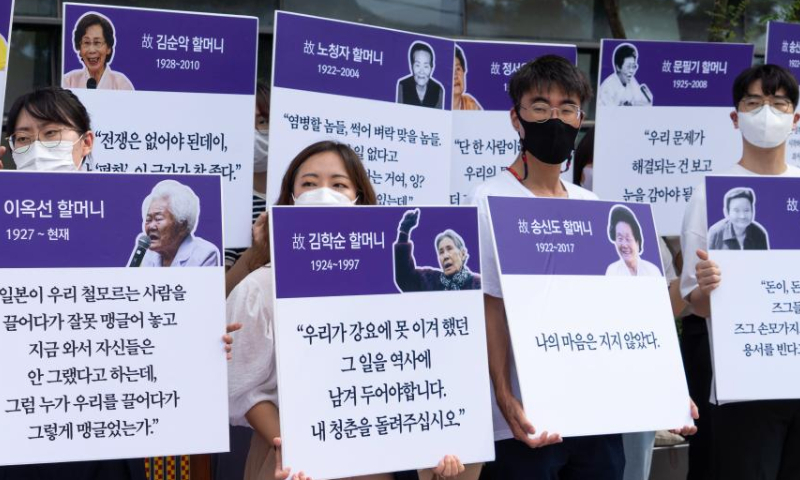 People hold portraits of comfort women and their testimonies during a protest rally held in Seoul, South Korea, Aug. 14, 2022. Comfort women refer to victims forced into sexual slavery by Japanese troops during World War II. The day of Aug. 14 was designated the International Memorial Day for Comfort Women in 2012 by the 11th Asian Alliance Conference for Comfort Women. Photo: Xinhua