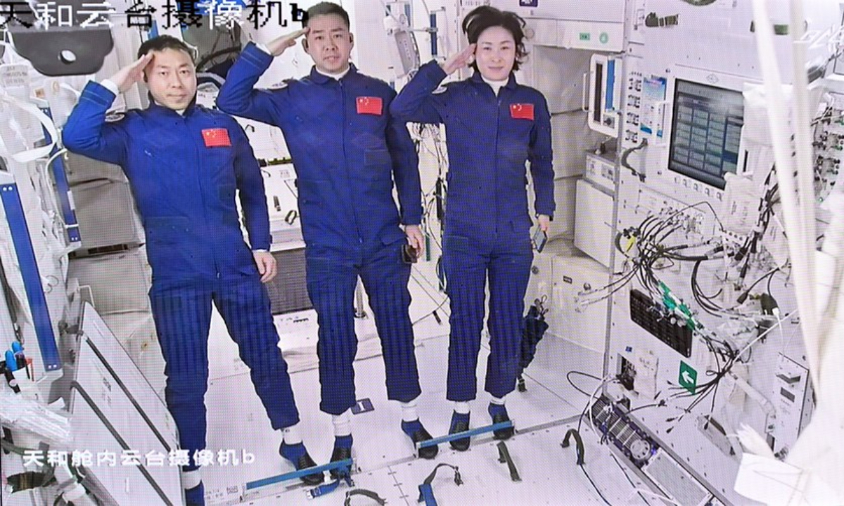 Screen image captured at Beijing Aerospace Control Center on June 5, 2022 shows three Chinese astronauts, Chen Dong (C), Liu Yang (R) and Cai Xuzhe, saluting after entering the space station core module Tianhe. Photo:Xinhua