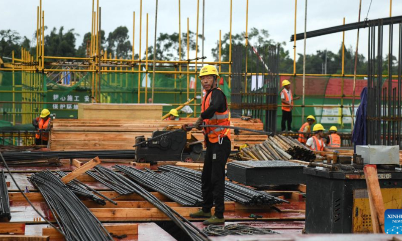 Workers operate at the construction site of Yulin North Railway Station in Yulin, south China's Guangxi Zhuang Autonomous Region, Aug. 12, 2022. Yulin North Railway Station, covering an area of 49,975 square meters, is one of the seven stations along the Nanning-Yulin high-speed railway with a designed speed of 350 kilometers per hour. Photo: Xinhua