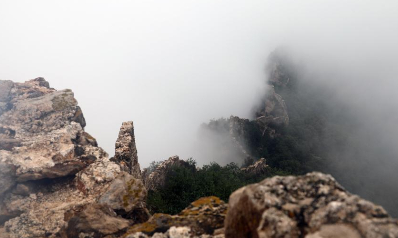 Photo taken on Aug. 9, 2022 shows the Jinshanling section of the Great Wall amid clouds in Luanping County, north China's Hebei Province. (Xinhua/Luo Xuefeng)