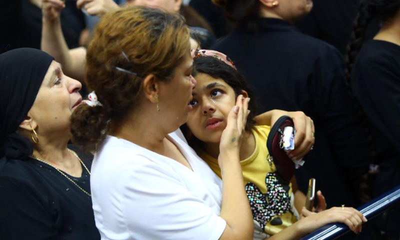 People mourn during a funeral for victims of a church massive fire in Giza, Egypt, on Aug. 14, 2022. At least 41 people were killed and 12 injured in a massive fire that broke out in a Coptic church in Egypt's Giza Province on Sunday, the Egyptian Health Ministry said. Photo: Xinhua