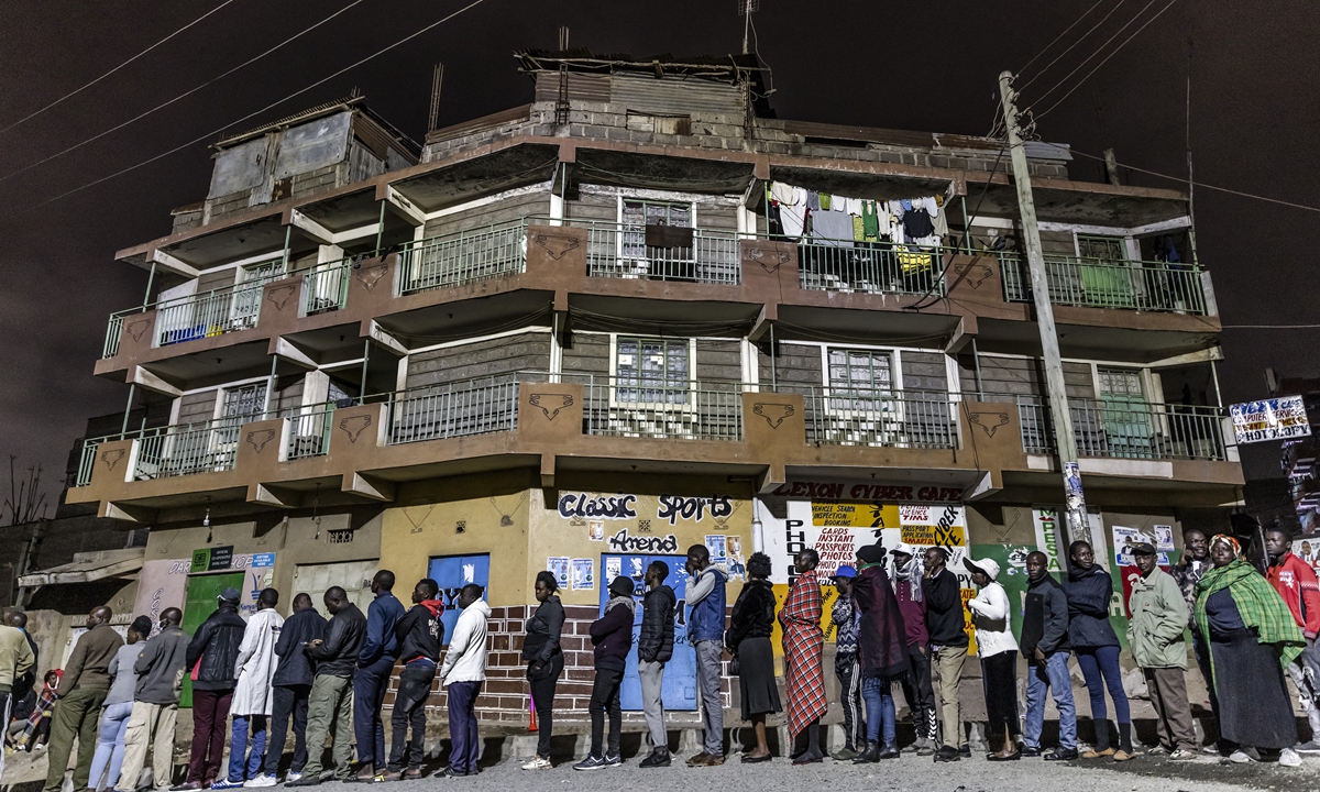 A group of voters queue while waiting for polls to open during Kenya's general election at St. Stephen School polling station in the informal settlement of Mathare in Nairobi, Kenya, on August 9, 2022. Kenya held its seventh general election since the introduction of multiparty politics in 1991 where some 22.1 million registered voters will elect the country's fifth president, members of the National Assembly, senators, and county governors. Photo: AFP