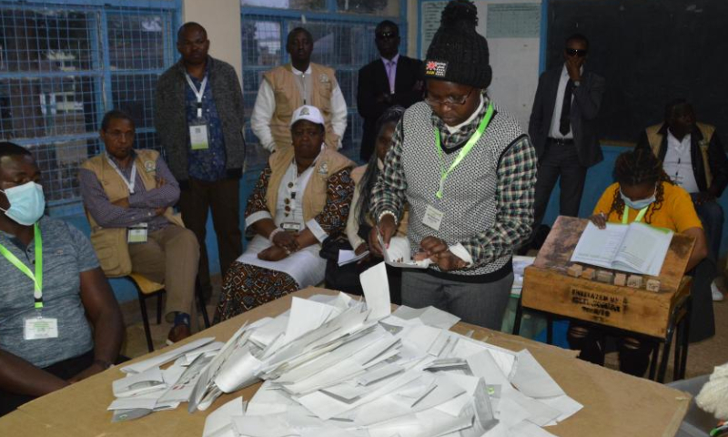 An official of Kenya's Independent Electoral and Boundaries Commission counts ballots at a polling station in Nairobi Aug. 9, 2022. Kenya on Tuesday held general elections for the country's fifth president, members of the National Assembly, senators, and county governors. (Photo by Charles Onyango/Xinhua)