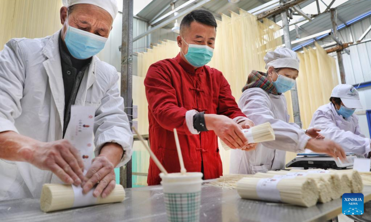 Li Changman (1st L) packs noodles in Meidi Village of Bao'an Township in Luonan County of Shangluo City, northwest China's Shaanxi Province, March 18, 2022. Photo:Xinhua