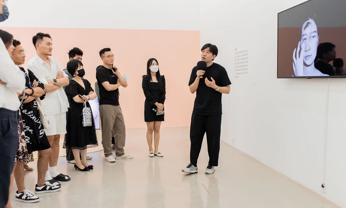 The curator leads a group of visitors during the exhibtion named <em>Soft Feelers</em> at Song Art Museum displaying in Beijing from August 6 to September 5, 2022. Photo: Courtesy of Kan Linlin