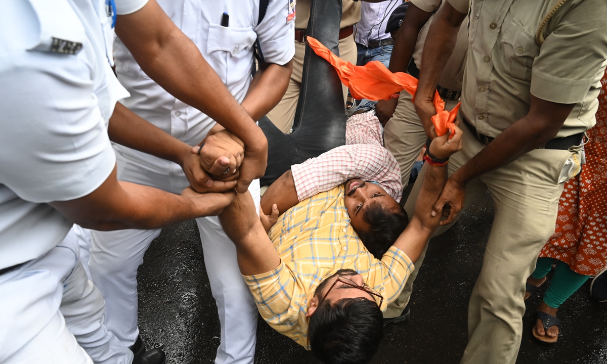 Police detain Bharatiya Janata Party activists during a protest against alleged irregularities in West Bengal state's government staff recruitment process, in Kolkata, India on August 10, 2022. Photo: AFP