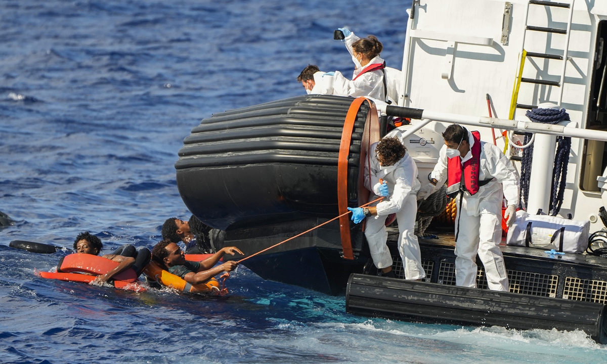 Italian coast guard members rescue migrants after their boat overturned and started to sink at the south of the Italian Lampedusa island at the Mediterranean Sea, on August 11, 2022. Forty people from Eritrea and Sudan were rescued by NGO Open Arms crew members and the Italian coast guard. Photo: VCG