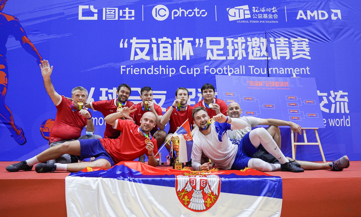 Champion Team Serbia take selfies at the podium of the Friendship Cup Football Tournament at the Chaoyang Gymnasium in Beijing on August 13, 2022. Photo: Official picture