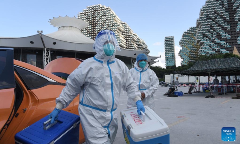 Volunteers transport nucleic acid samples in Sanya, south China's Hainan Province, Aug. 14, 2022. Sanya has optimized the processes of nucleic acid testing amid the latest COVID-19 resurgence. (Xinhua/Zhao Yingquan)