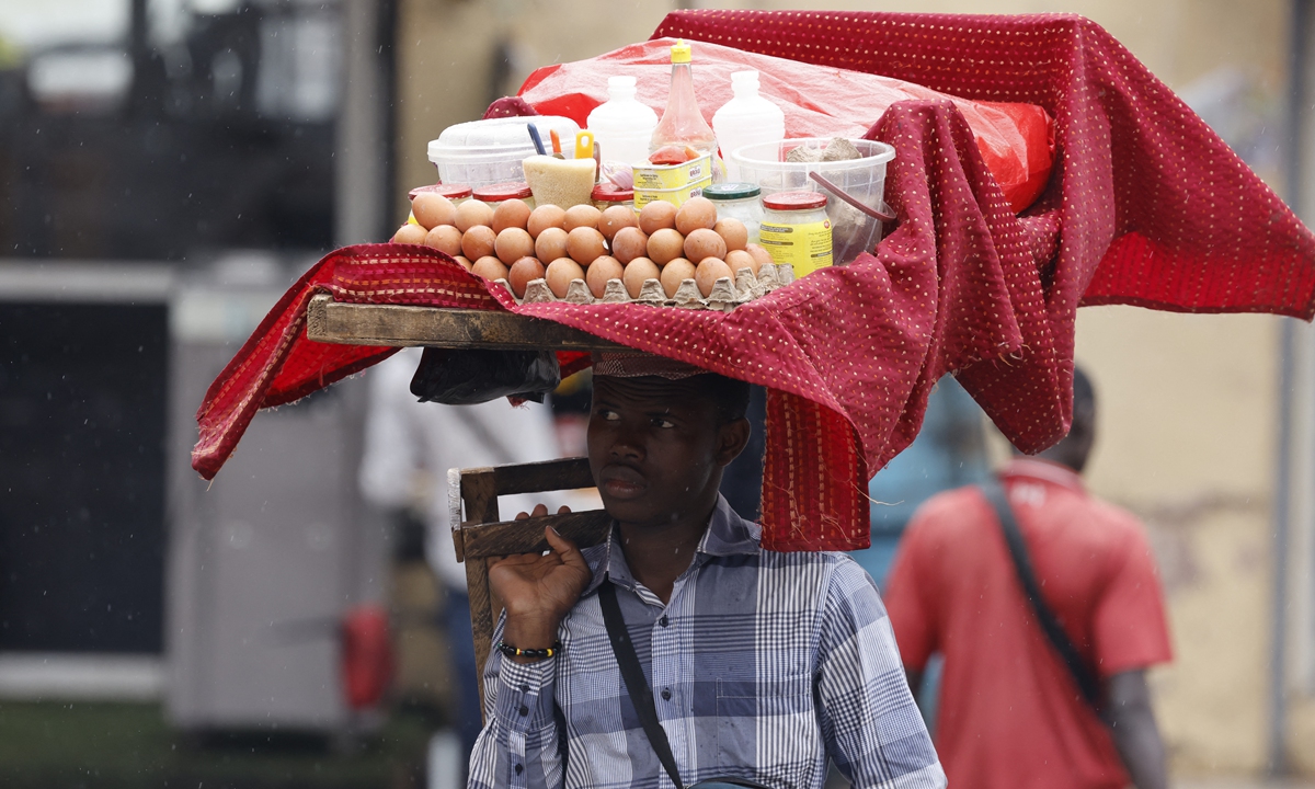 Vendors carry goods in Yaounde, Cameroon, on July 25, 2022. Photos: AFP