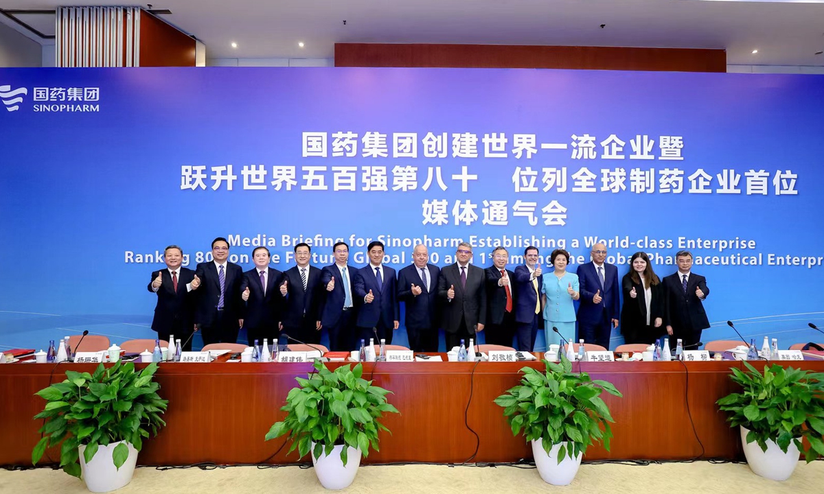 Sinopharm officials and envoys thumb up for Chinese vaccines at the media briefing session on Monday. Photo: Courtesy of Sinopharm