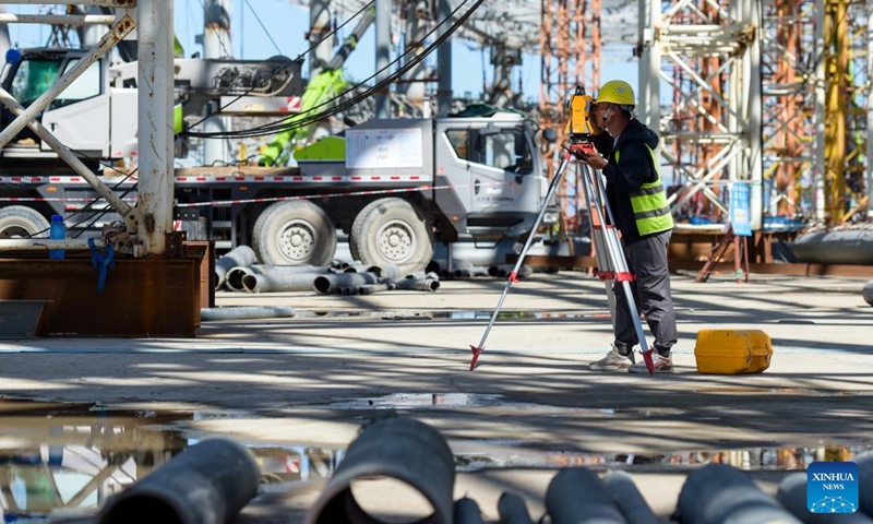 A laborer works at the construction site of a new airport in Hohhot, north China's Inner Mongolia Autonomous Region, Aug. 15, 2022. The main structure of the terminal of a new airport in Hohhot has been completed. (Xinhua/Li Zhipeng)