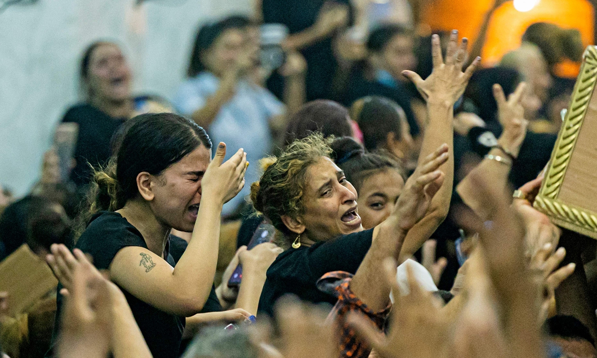 Mourners react during the funeral of victims killed in the Cairo Coptic church fire, at the church of the Blessed Virgin Mary in the Giza Governorate, Egypt on August 14, 2022. Photo: AFP