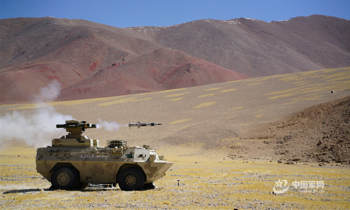 A self-propelled anti-tank missile launcher attached to a combined-arms regiment under the PLA Xinjiang Military Command fires anti-tank missiles at a mock target during a recent live-fire training exercise in a shooting range at the altitude of 5,200 meters. (eng.chinamil.com.cn/Photo by Zou Wenchuan)