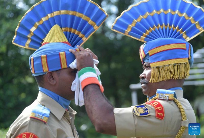 Soldiers adjust their dresses and hats before the parade during Independence Day function at Assam Rifles ground in Agartala, capital city of India's northeastern state of Tripura, Aug. 15, 2022. (Str/Xinhua)