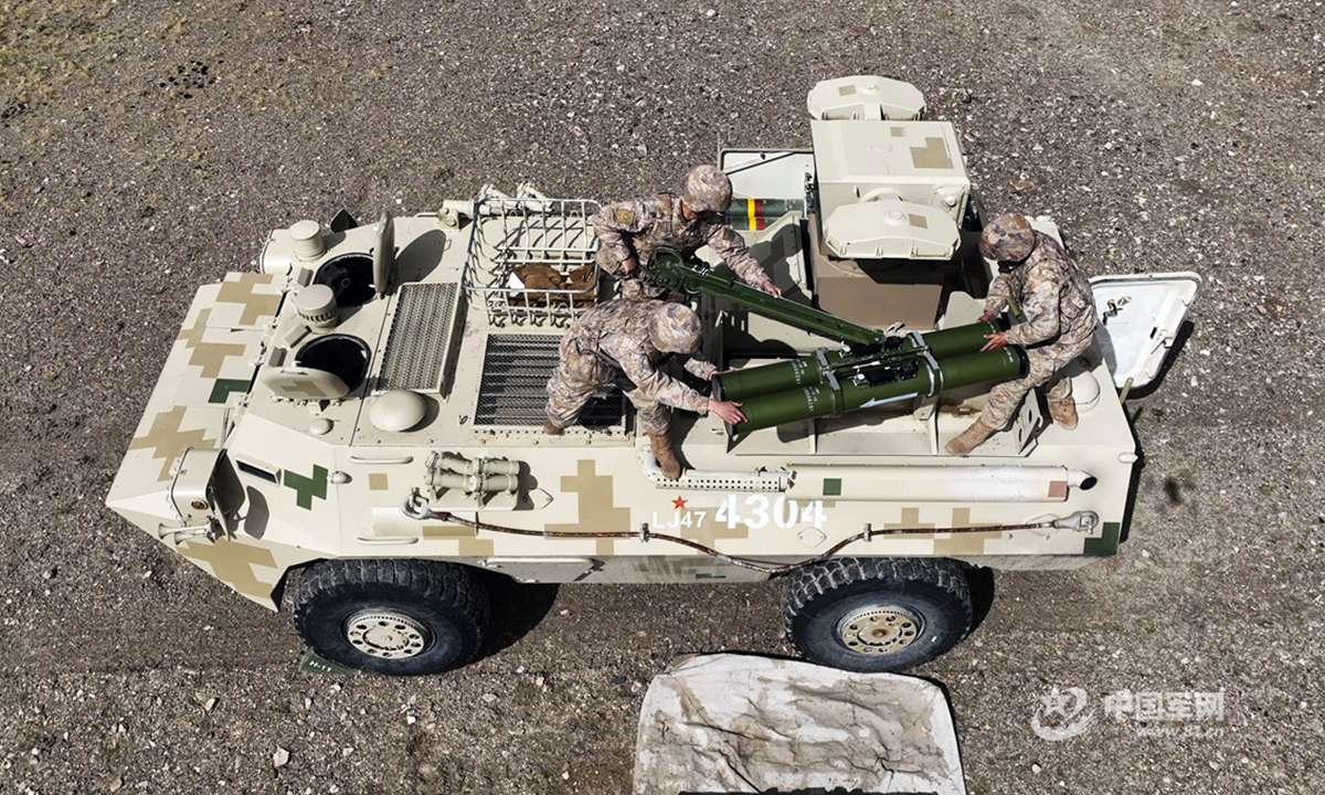 Troops assigned to a combined-arms regiment under the PLA Xinjiang Military Command mount anti-tank missiles onto a self-propelled anti-tank missile launcher during a recent live-fire training exercise in a shooting range at the altitude of 5,200 meters. (eng.chinamil.com.cn/Photo by He Xuan)