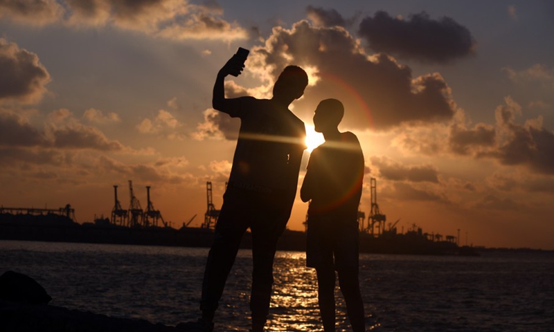People enjoy the sunset at the beach of Alexandria, Egypt, on Aug.13, 2022.(Photo: Xinhua)