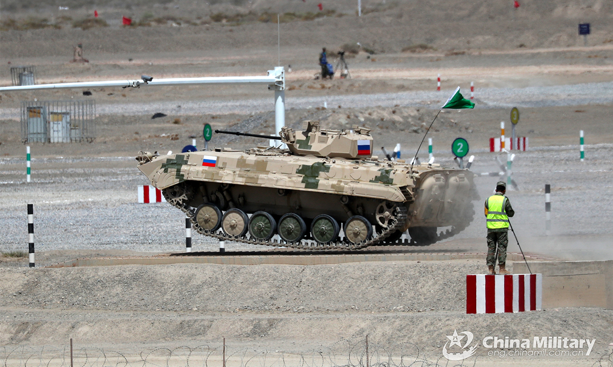 An infantry fighting vehicle of the Russian team crosses the treadway bridge setup in the first round of individual race of the Suvorov Onslaught contest in Korla, China's Xinjiang Uygur Autonomous Region, on August 14, 2022. The Suvorov Onslaught of the International Army Games 2022 (IAG 2022) kicked off on August 14 with participation of six teams from five countries, namely China, Russia, Belarus, Iran and Venezuela. (Photo by Luo Xingcang)